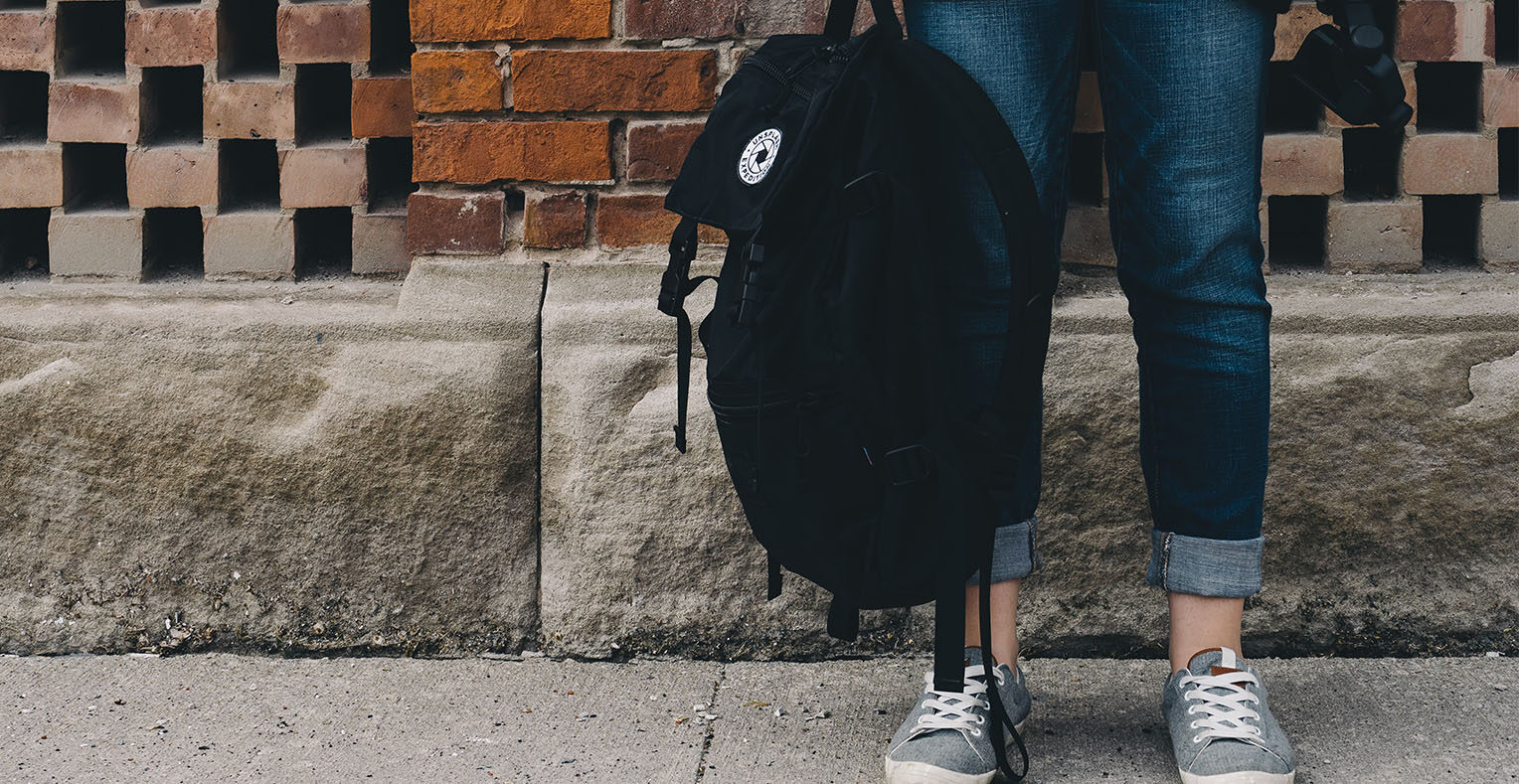 Person holding schoolbag