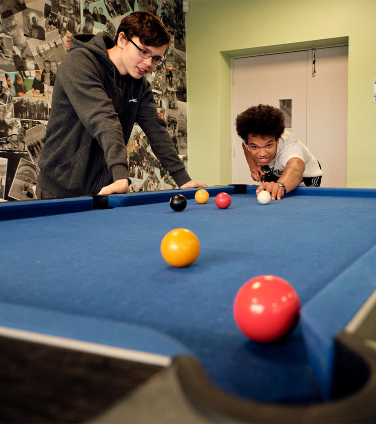 Two youths playing pool